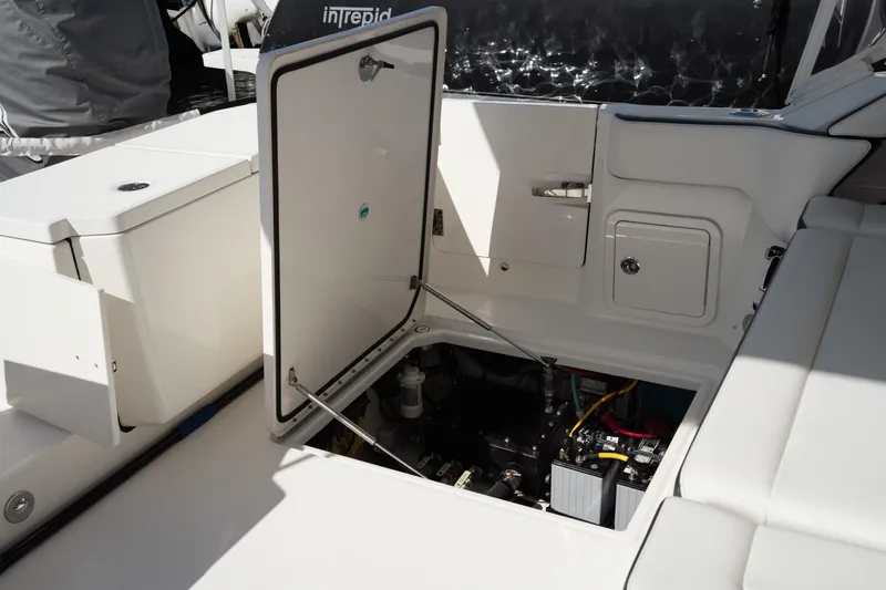 Slide: The Image of 2024 World Cat 400 DC-X boat interior with open hatch revealing engine compartment. - 28