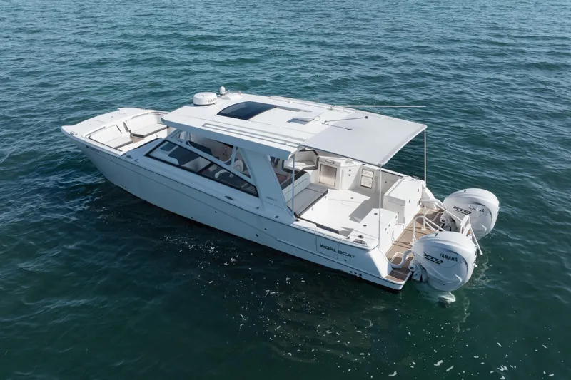 Slide: The Image of 2024 World Cat 400 DC-X boat on open water, featuring dual Yamaha engines. - 6