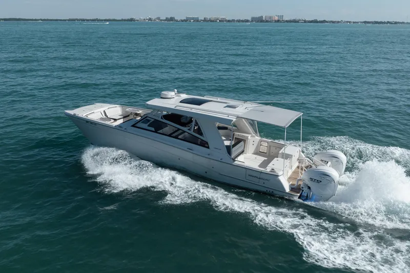 Slide: The Image of 2024 World Cat 400 DC-X cruising on open water, showcasing sleek design and powerful engines. - 9