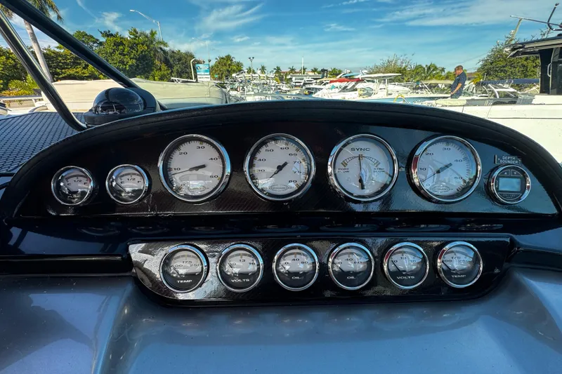 Slide: The Image of Dashboard of a 2005 Cobolt 36 boat with various gauges and controls. - 13