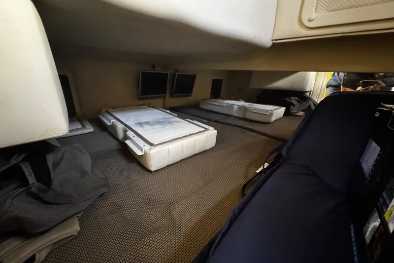 Slide: The Image of Interior cabin of a 2005 Cobolt 36 boat, featuring storage compartments and seating. - 19