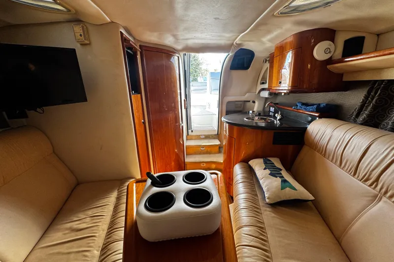Slide: The Image of Interior of a 2005 Cobolt 36 boat with cozy seating and wooden cabinetry. - 25