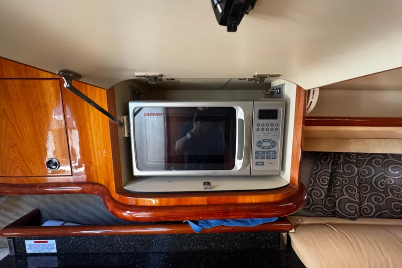 Slide: The Image of 2005 Cobolt 36 interior with built-in microwave in wooden cabinet. - 27