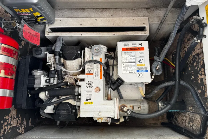 Slide: The Image of Engine compartment of a 2005 Cobolt 36 with visible components and fire extinguisher. - 28