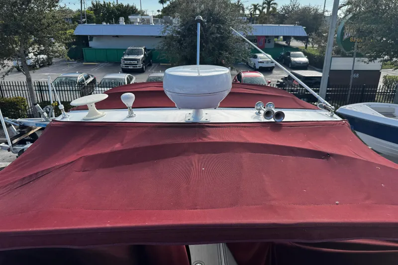Slide: The Image of Red canopy on a 2005 Cobolt 36 boat with radar and antennas. - 36