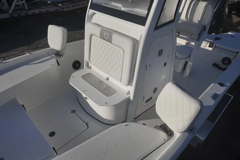 Slide: The Image of 2026 Sea Fox 231 Bay Fox boat interior with white cushioned seating and storage compartments. - 11