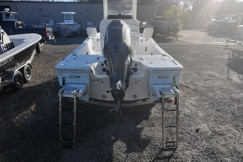 Slide: The Image of 2026 Sea Fox 231 Bay Fox boat with outboard motor and dual ladders in a marina. - 17