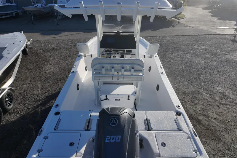 Slide: The Image of 2026 Sea Fox 231 Bay Fox boat with Yamaha 200 engine, docked outdoors. - 18