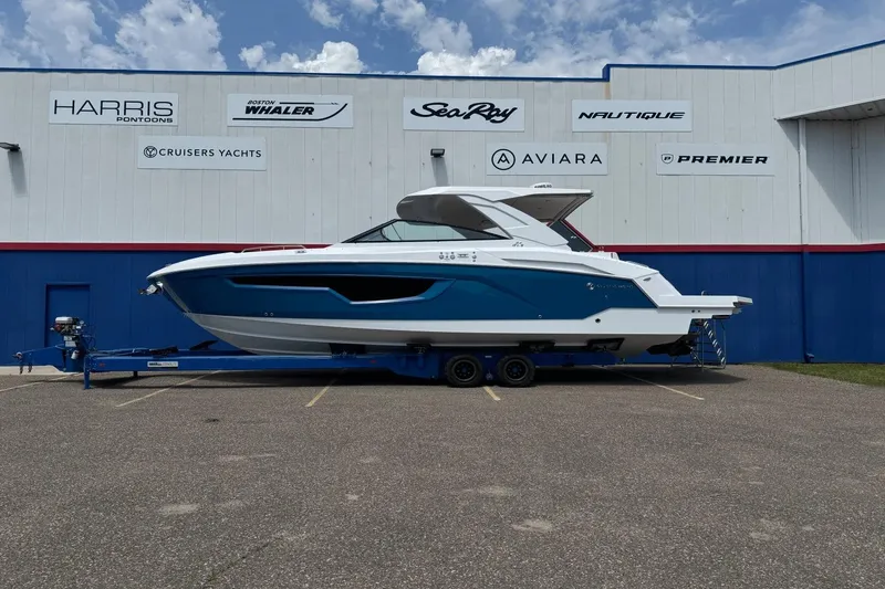The Image of 2026 Cruisers Yachts 34 GLS I/O boat on trailer outside dealership. - 0