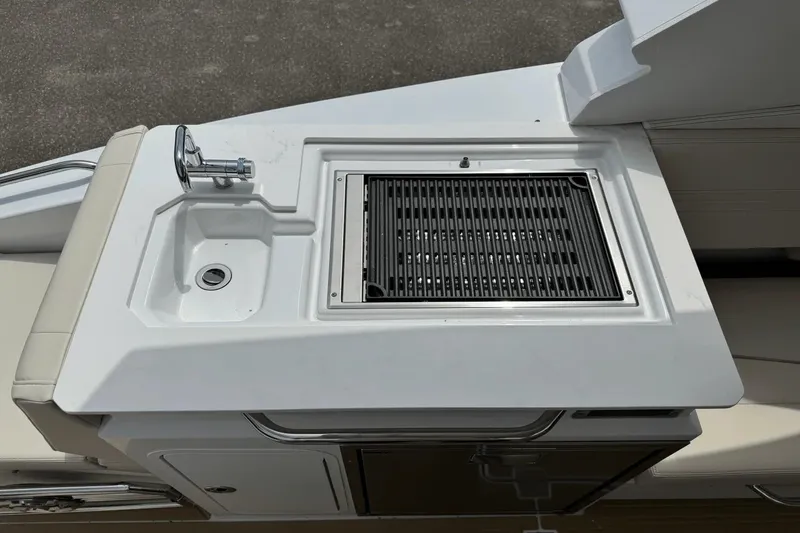 Slide: The Image of 2026 Cruisers Yachts 34 GLS I/O boat kitchenette with sink and grill. - 21