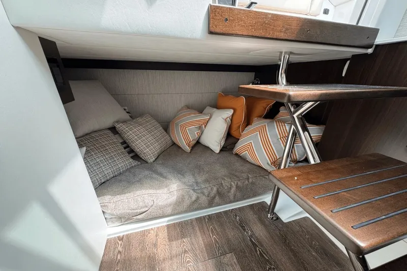 Slide: The Image of Cozy cabin interior of 2026 Cruisers Yachts 34 GLS I/O with cushions and wooden steps. - 28
