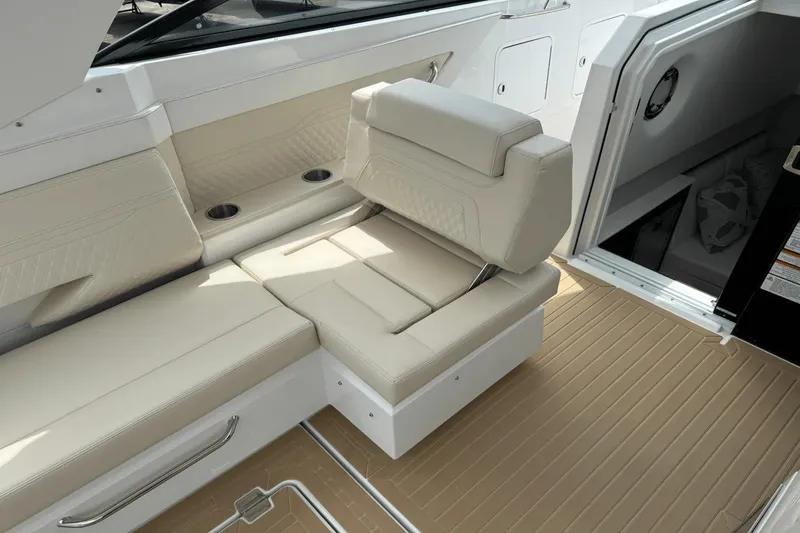 Slide: The Image of 2026 Cruisers Yachts 34 GLS I/O interior with beige seating and cup holders. - 12
