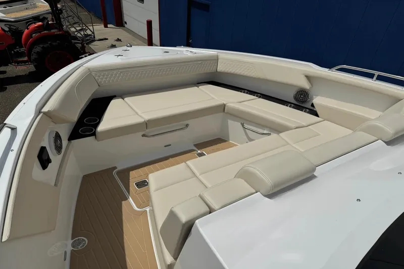 Slide: The Image of 2026 Cruisers Yachts 34 GLS I/O boat interior with beige seating and cup holders. - 15