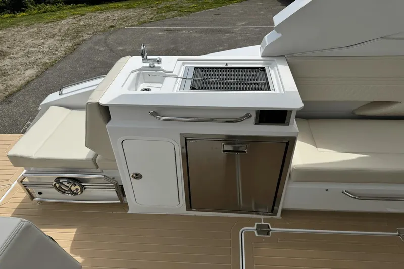 Slide: The Image of 2026 Cruisers Yachts 34 GLS I/O boat with outdoor kitchen and seating area. - 20