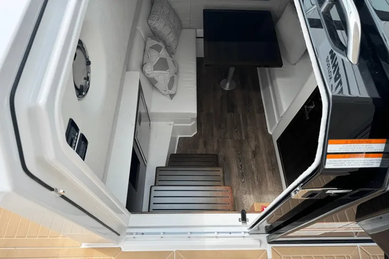 Slide: The Image of 2026 Cruisers Yachts 34 GLS I/O cabin interior with seating and table. - 23