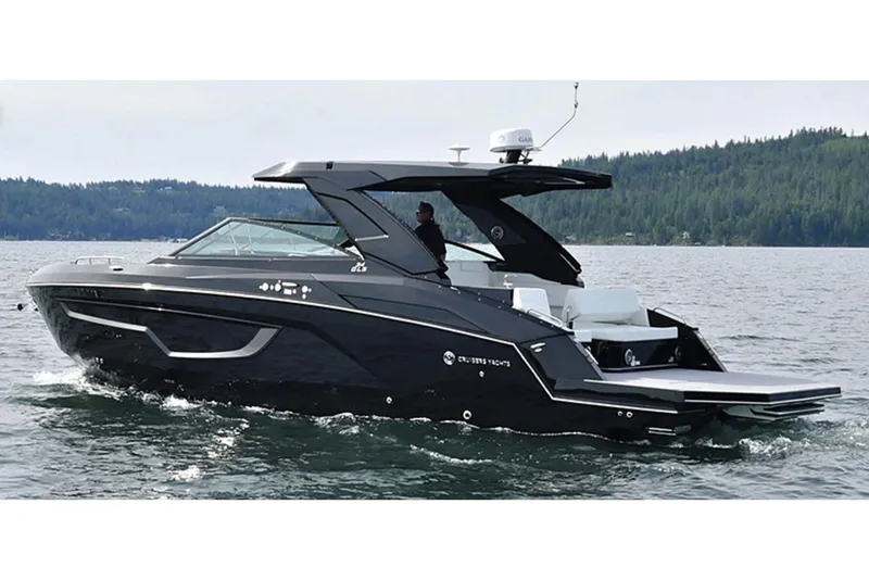Slide: The Image of Manufacturer Provided Image: 2026 Cruisers Yachts 34 GLS I/O cruising on a serene lake with forested backdrop. - 37