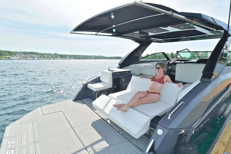 Slide: The Image of Manufacturer Provided Image: 2026 Cruisers Yachts 34 GLS I/O with sunbathing area on a serene lake. - 38