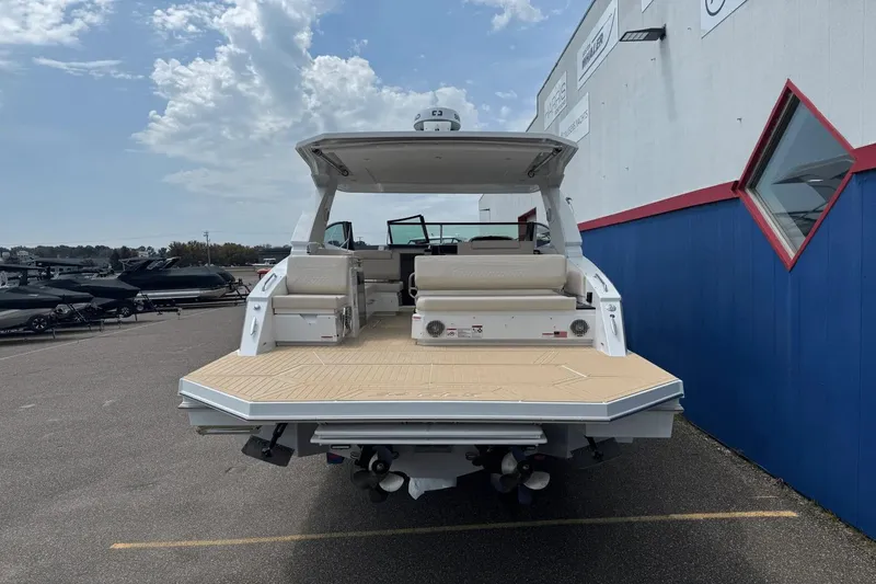 Slide: The Image of 2026 Cruisers Yachts 34 GLS I/O boat, rear view, docked outdoors. - 4