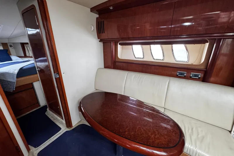 Slide: The Image of Interior of 2006 Sea Ray 38 Sundancer yacht with dining area and cabin view. - 10