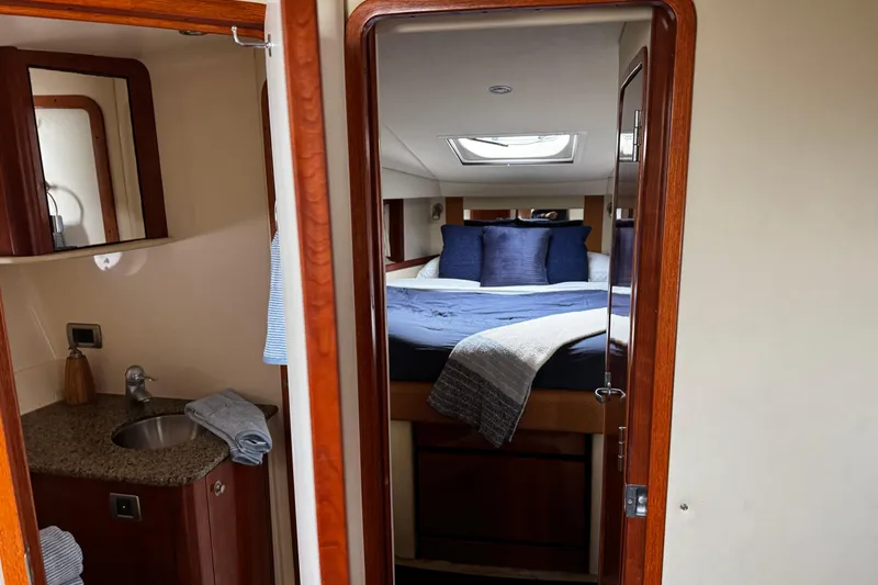 Slide: The Image of Interior of 2006 Sea Ray 38 Sundancer yacht with cozy bedroom and compact bathroom. - 12