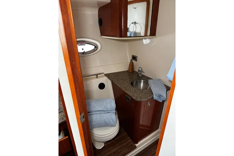 Slide: The Image of Luxurious 2006 Sea Ray 38 Sundancer bathroom with wood accents and granite countertop. - 15