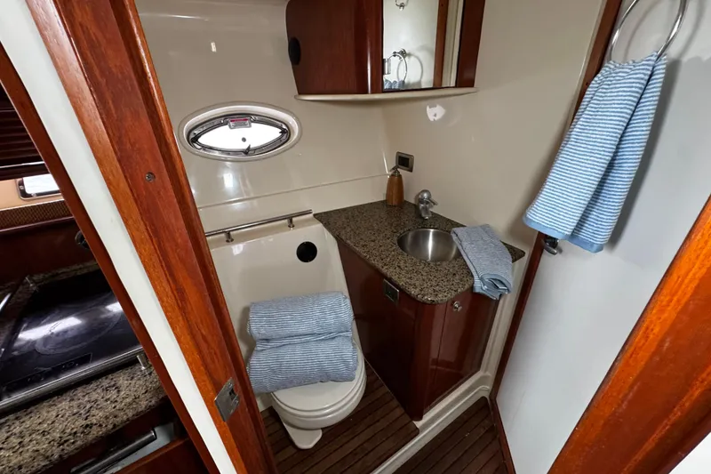 Slide: The Image of Luxurious bathroom in 2006 Sea Ray 38 Sundancer yacht with wood accents and granite countertop. - 16