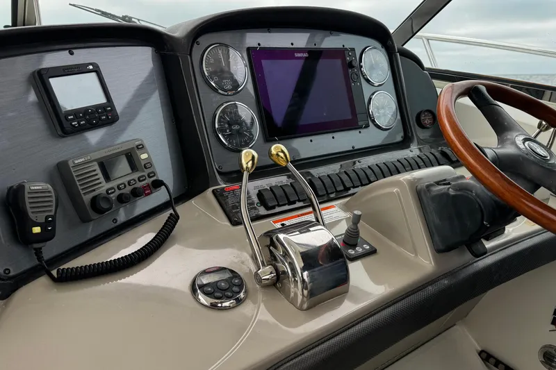 Slide: The Image of Helm of 2006 Sea Ray 38 Sundancer with navigation instruments and wooden steering wheel. - 17