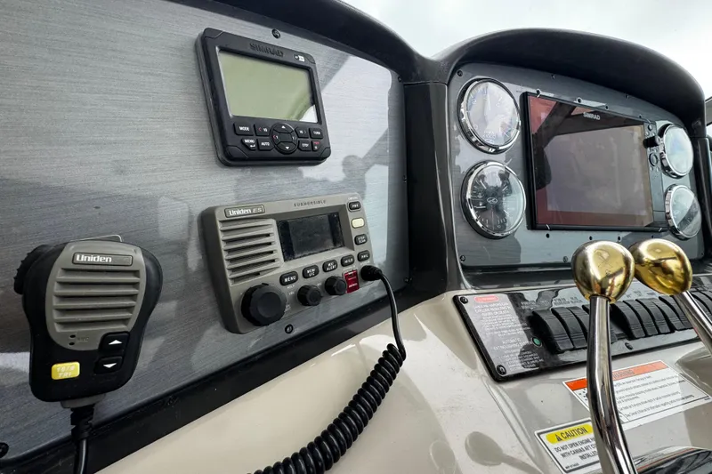 Slide: The Image of Control panel of 2006 Sea Ray 38 Sundancer with navigation and communication equipment. - 18