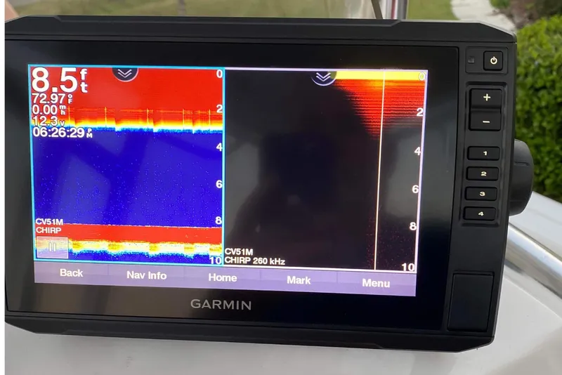 Slide: The Image of 2014 Sportsman Heritage 211 Center Console boat on trailer under metal shelter. - 11