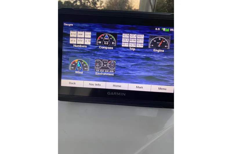 Slide: The Image of 2014 Sportsman Heritage 211 Center Console boat under metal canopy. - 12