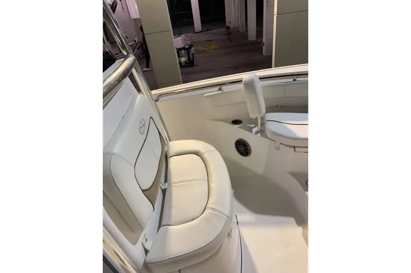 Slide: The Image of 2014 Sportsman Heritage 211 Center Console boat interior, featuring seating and console area. - 14