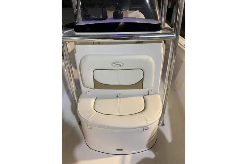 Slide: The Image of 2014 Sportsman Heritage 211 Center Console boat under metal shelter. - 15