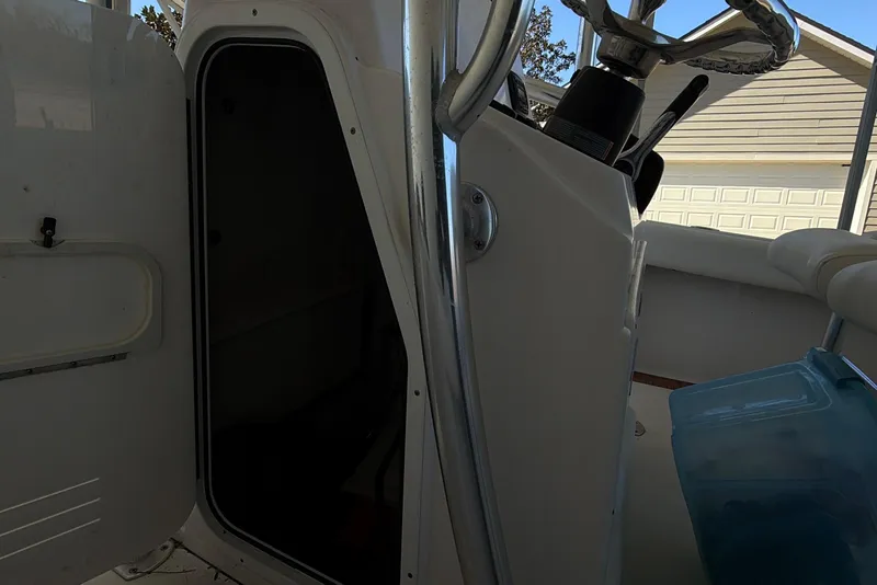 Slide: The Image of 2014 Sportsman Heritage 211 Center Console boat with open storage compartment. - 27