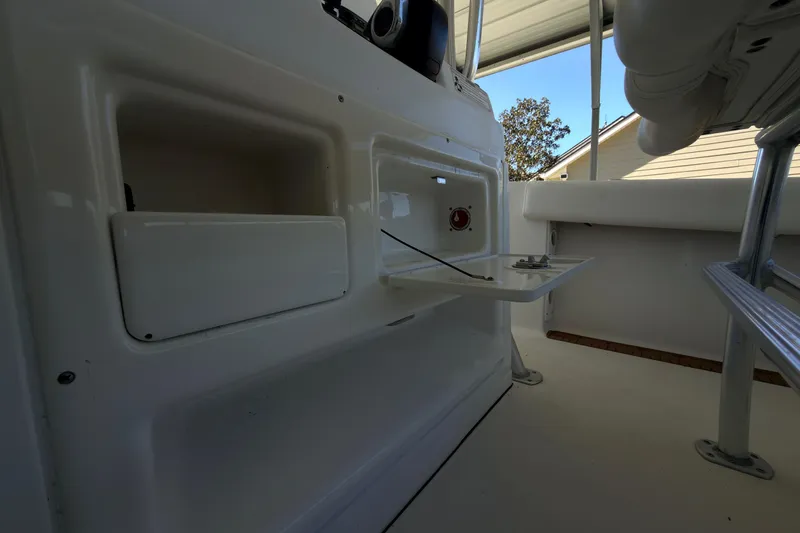 Slide: The Image of 2014 Sportsman Heritage 211 Center Console boat interior with storage compartments. - 32