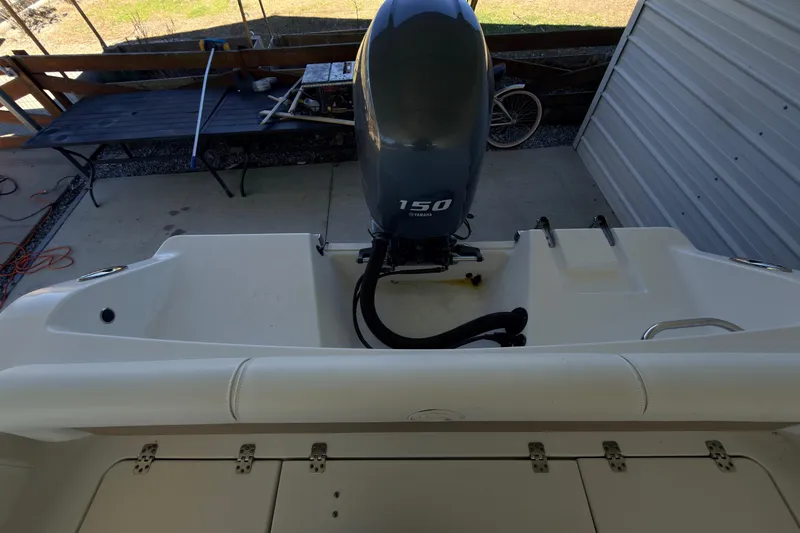 Slide: The Image of 2014 Sportsman Heritage 211 Center Console boat under metal shelter. - 34