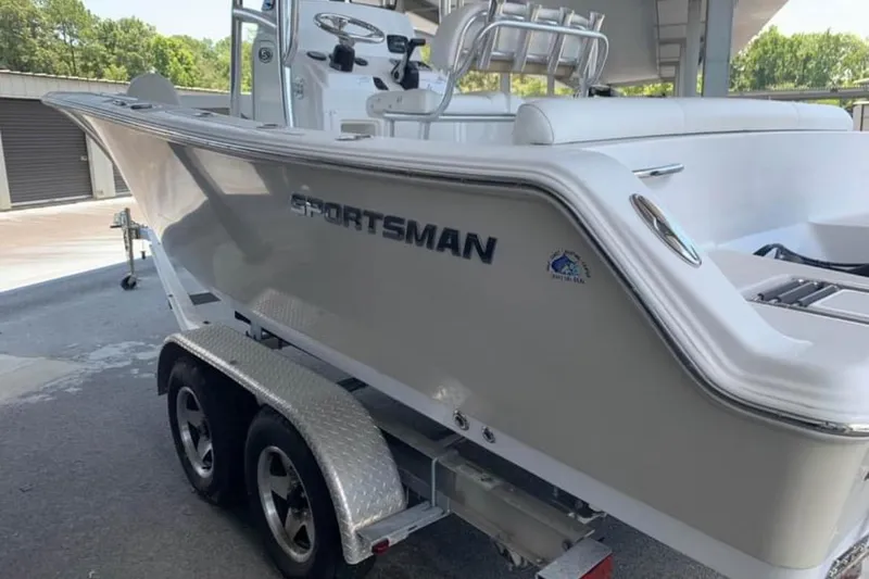 Slide: The Image of 2014 Sportsman Heritage 211 Center Console boat with 150 horsepower engine in covered storage. - 4