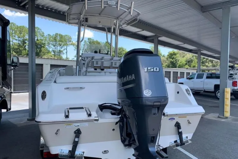 Slide: The Image of 2014 Sportsman Heritage 211 Center Console with Yamaha outboard motor in a driveway setting. - 7