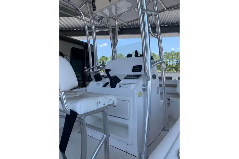 Slide: The Image of 2014 Sportsman Heritage 211 Center Console boat on trailer under shelter. - 8