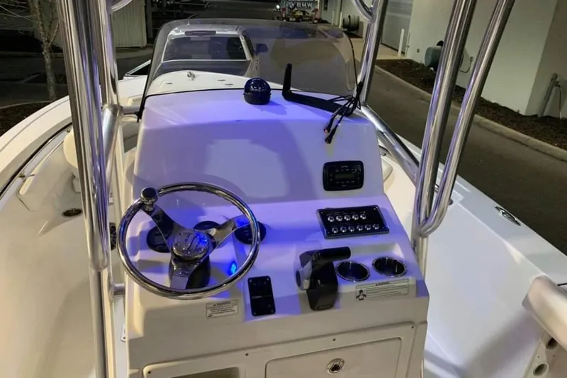 Slide: The Image of 2014 Sportsman Heritage 211 Center Console boat on trailer under metal carport. - 9