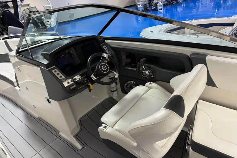 Slide: The Image of 2021 Chaparral 30 Surf boat interior with modern helm and comfortable seating. - 14