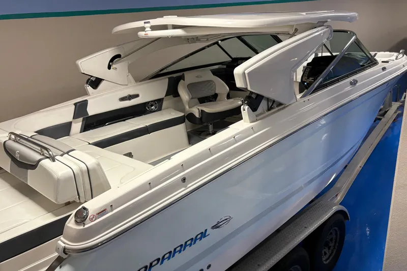 Slide: The Image of 2021 Chaparral 30 Surf boat with sleek white interior and modern design. - 2