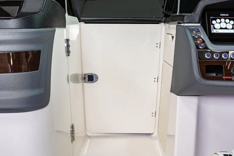Slide: The Image of Manufacturer Provided Image: 2021 Chaparral 30 Surf boat interior with control panel and cabin door. - 25