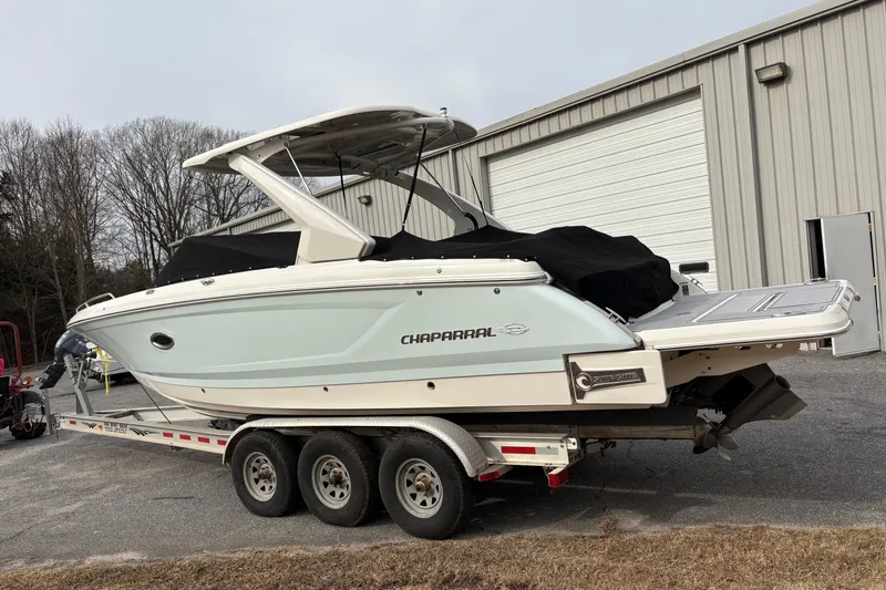 Slide: The Image of 2021 Chaparral 30 Surf boat on trailer near industrial building. - 4