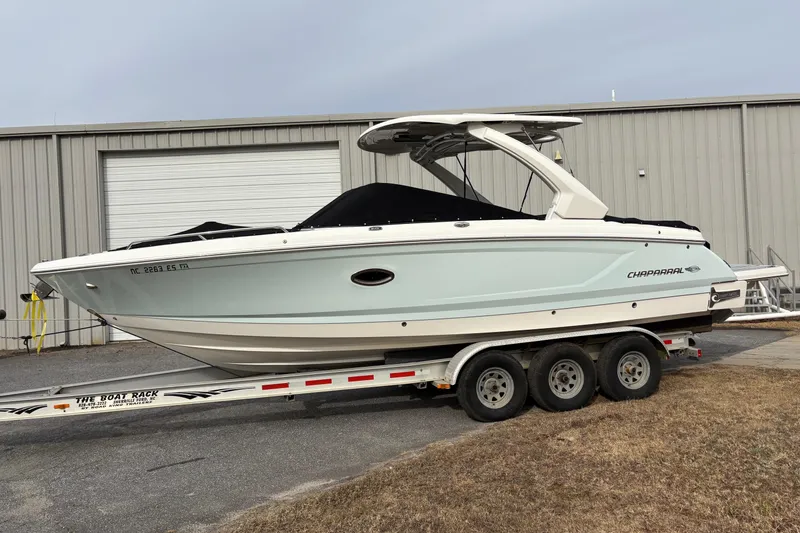 Slide: The Image of 2021 Chaparral 30 Surf boat on trailer, parked outside a warehouse. - 5