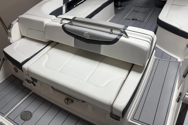 Slide: The Image of 2021 Chaparral 30 Surf boat interior with white cushioned seating and sleek design. - 7