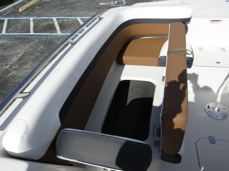 Slide: The Image of 2024 Starcraft SVX 191 OB CC boat seating area with brown and white cushions. - 11