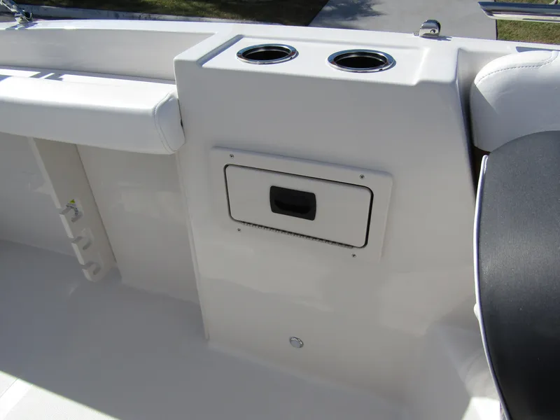 Slide: The Image of 2024 Starcraft SVX 191 OB CC boat interior with cup holders and storage compartment. - 17