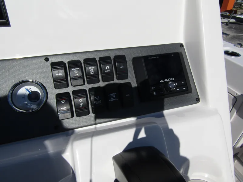 Slide: The Image of 2024 Starcraft SVX 191 OB CC boat control panel with switches and JL Audio system. - 26