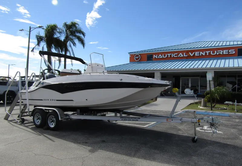 Slide: The Image of 2024 Starcraft SVX 191 OB CC boat on trailer outside Nautical Ventures dealership. - 5