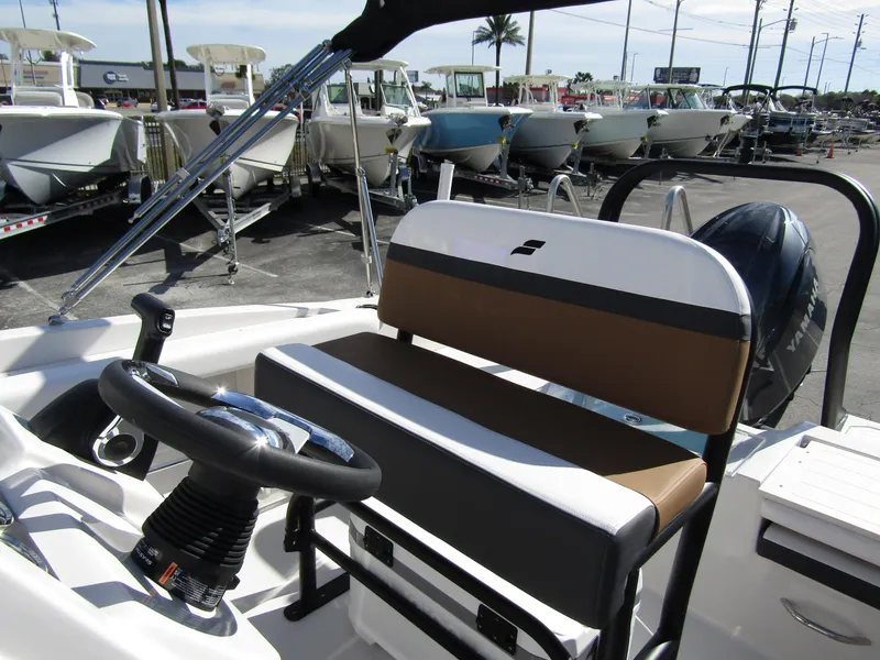 Slide: The Image of 2024 Starcraft SVX 191 OB CC boat interior with steering wheel and seating. - 22
